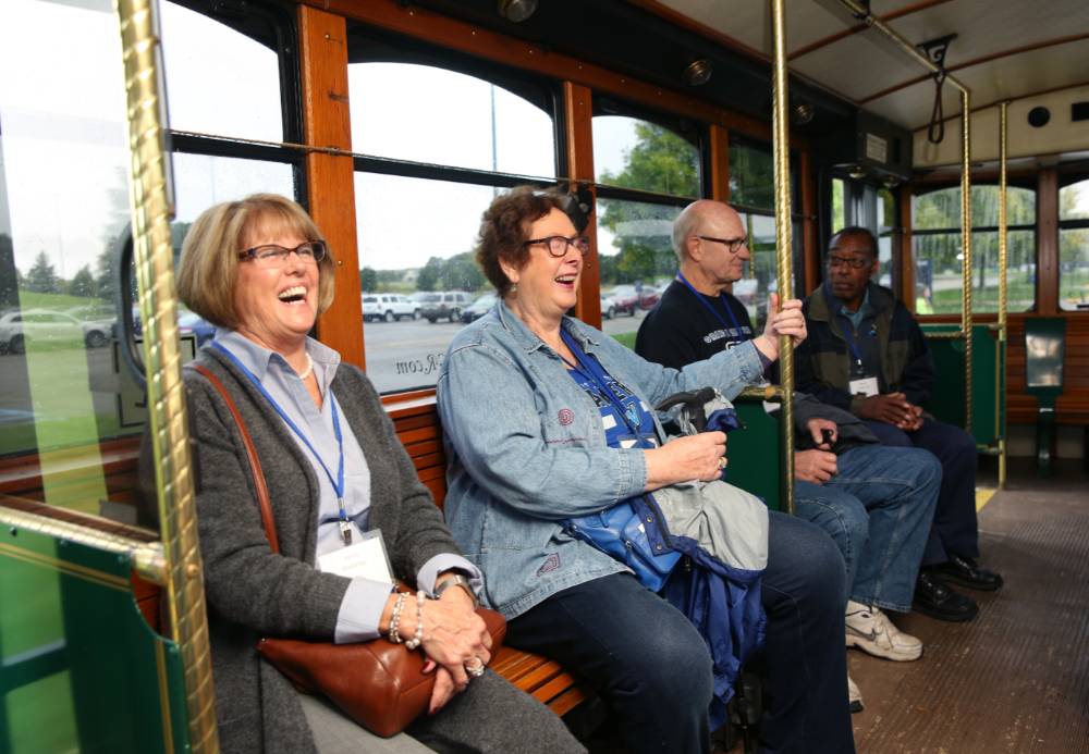 Alumni laughing on the Trolley.